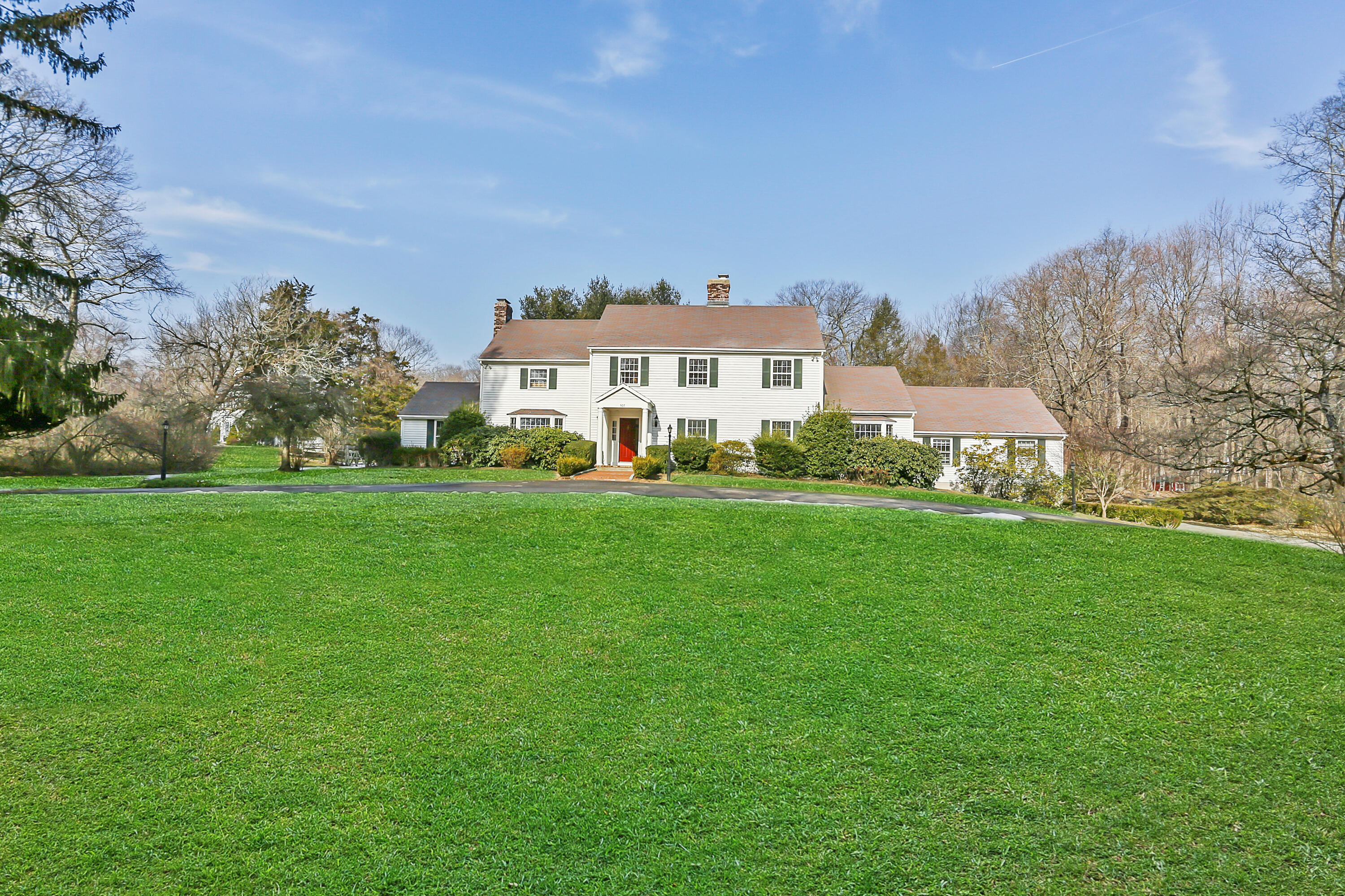 507 Brookside Road New Canaan, CT 06840 - Photo 1 of 36 a front view of a house with a yard