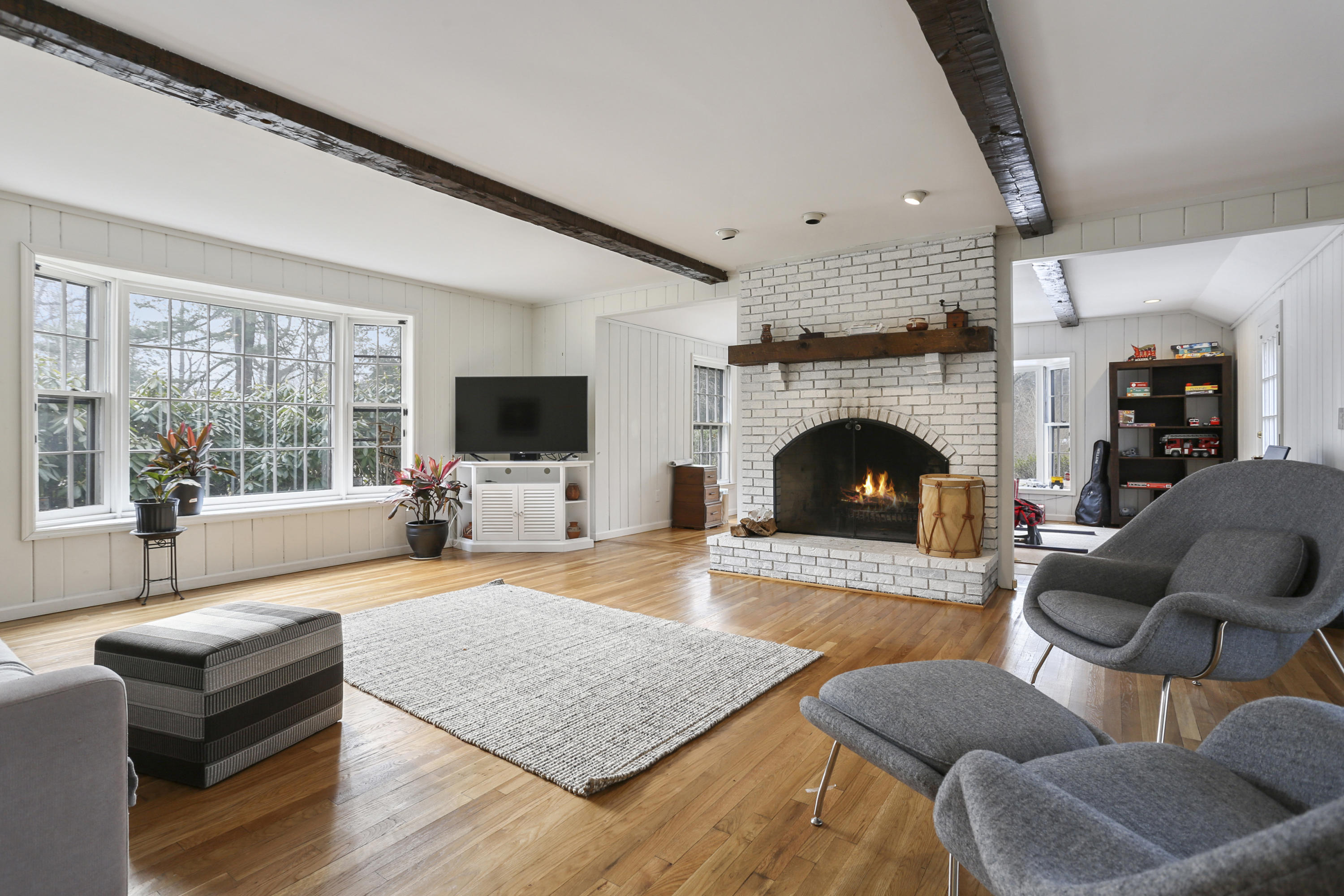 507 Brookside Road New Canaan, CT 06840 - Photo 18 of 36 a living room with furniture flat screen tv and a fireplace