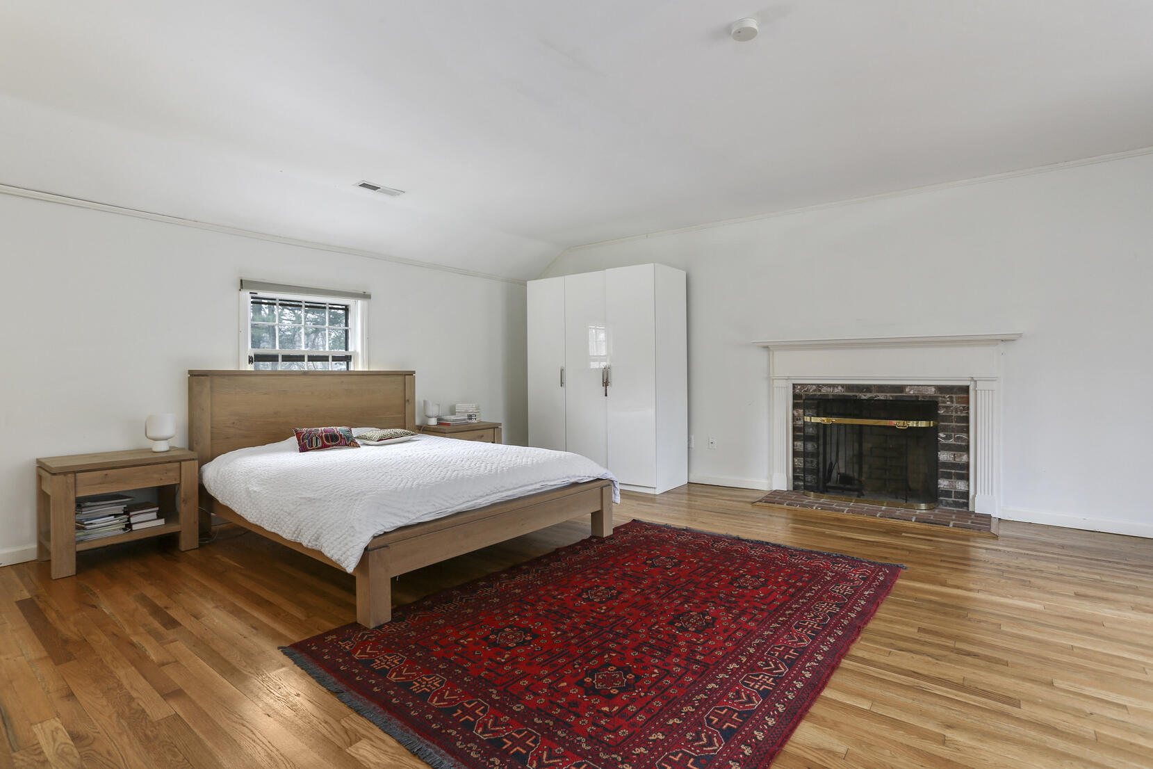 507 Brookside Road New Canaan, CT 06840 - Photo 24 of 36 a bedroom with a bed and a fireplace