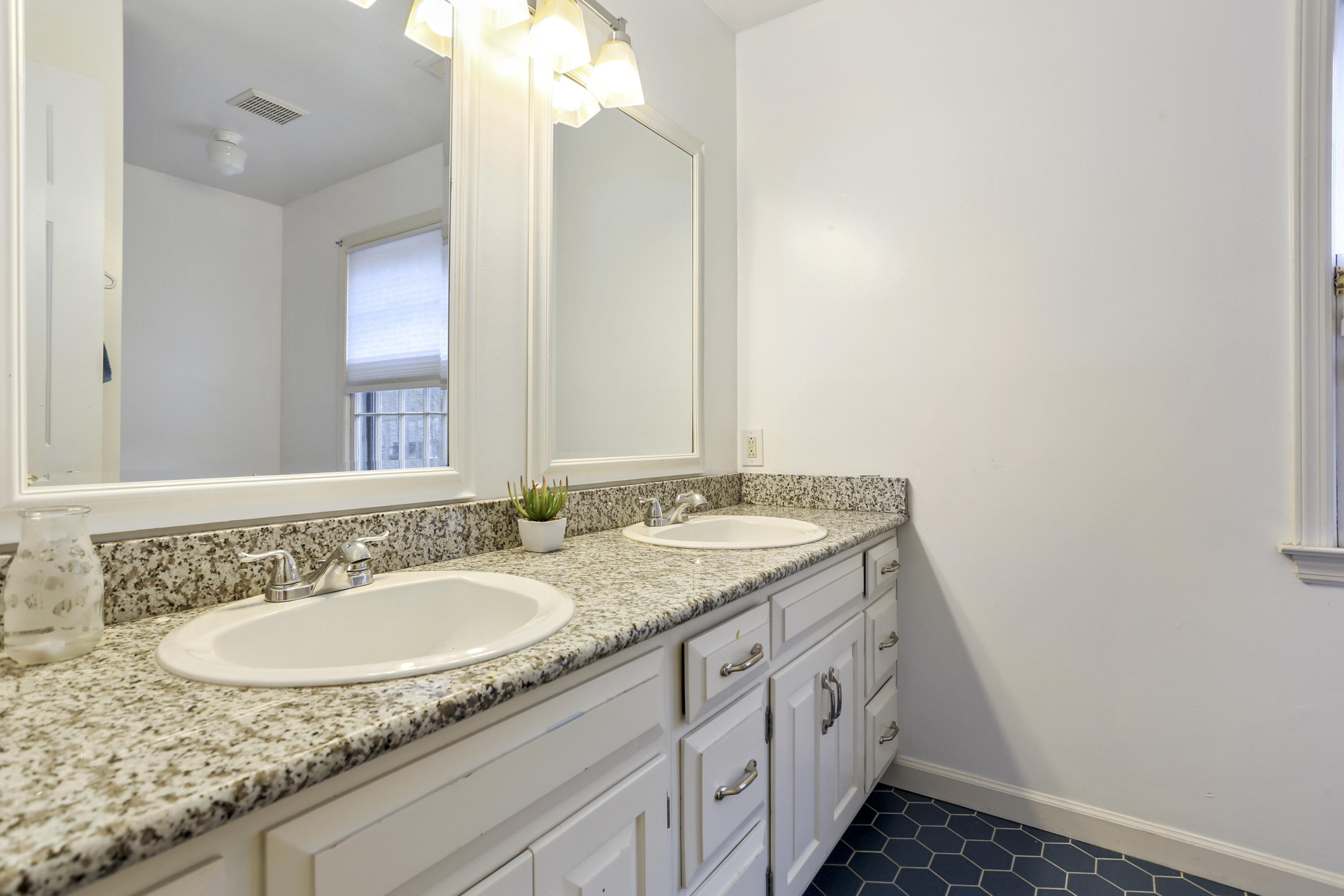 507 Brookside Road New Canaan, CT 06840 - Photo 27 of 36 a bathroom with a granite countertop sink and a mirror