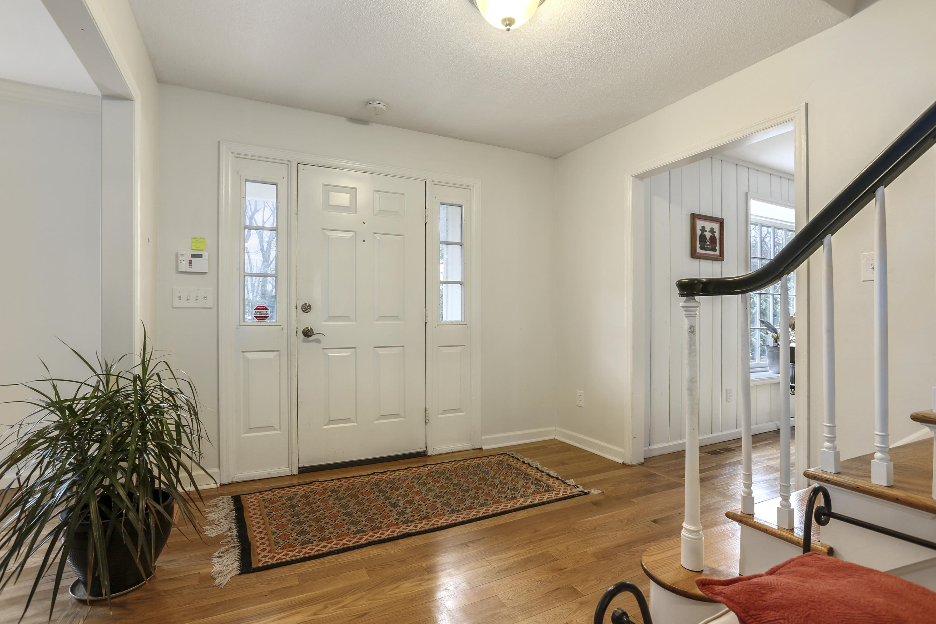 507 Brookside Road New Canaan, CT 06840 - Photo 6 of 36 a view of a hallway with wooden floor and staircase