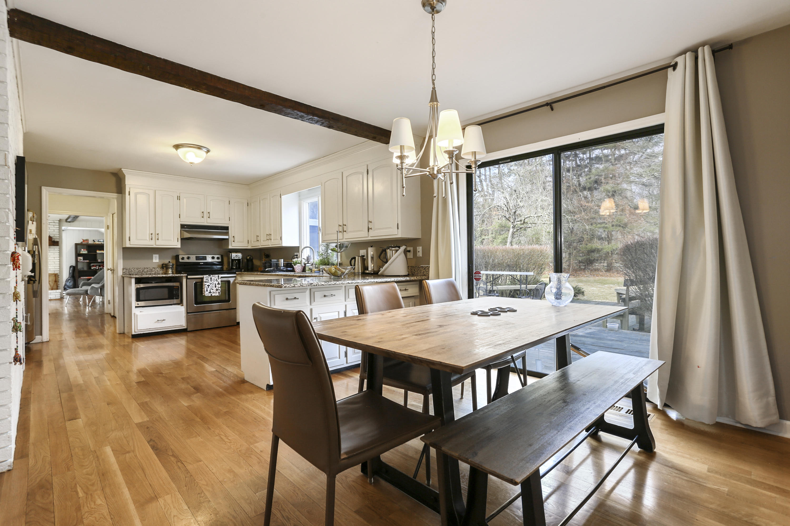 507 Brookside Road New Canaan, CT 06840 - Photo 10 of 36 a dining room with stainless steel appliances granite countertop a table chairs and a kitchen view