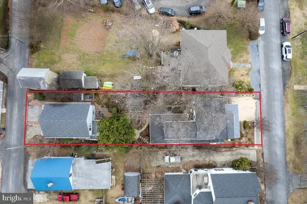 a front view of a house with a yard covered in snow