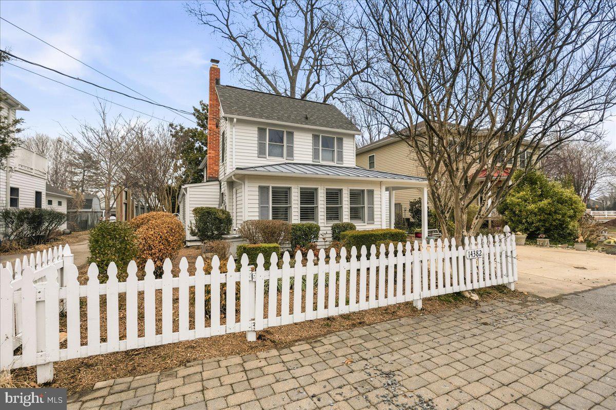 14382 Sedwick Avenue Solomons, MD 20688 - Photo 11 of 90 a front view of a house with a garden