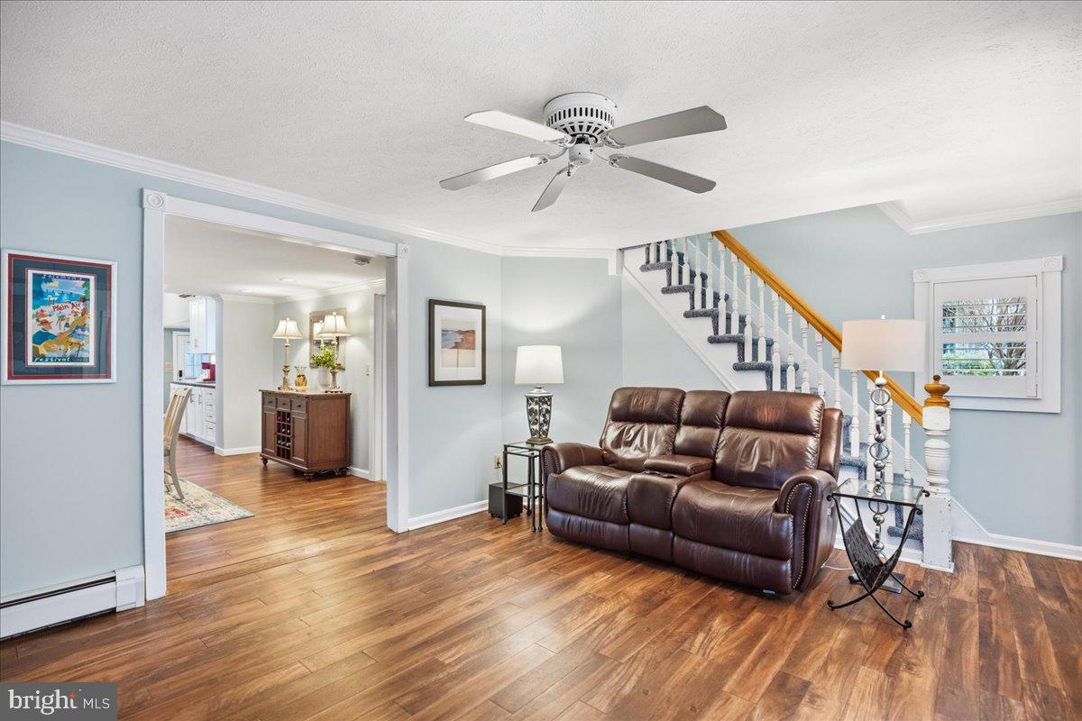 14382 Sedwick Avenue Solomons, MD 20688 - Photo 15 of 90 a living room with furniture and a wooden floor