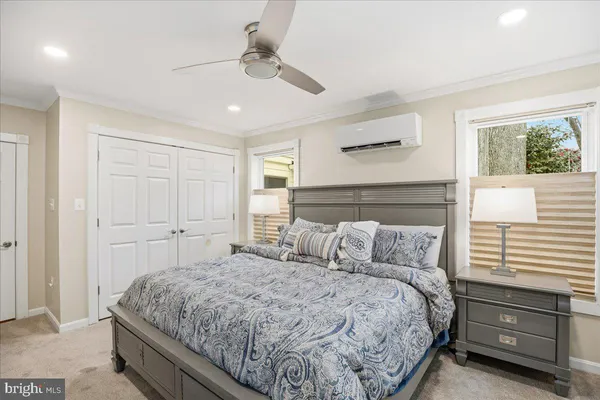 a bedroom with a large bed and a chandelier