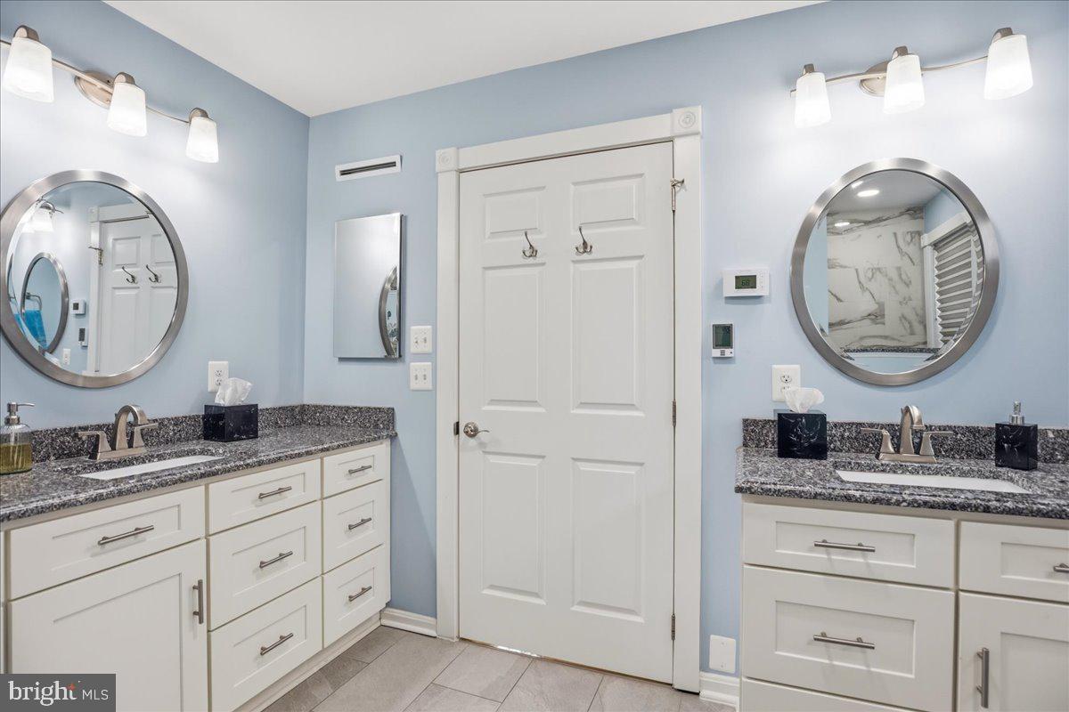 14382 Sedwick Avenue Solomons, MD 20688 - Photo 21 of 90 a bathroom with a granite countertop double vanity sink and a mirror