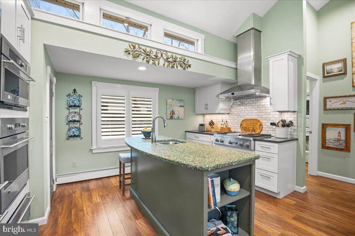 14382 Sedwick Avenue Solomons, MD 20688 - Photo 31 of 90 a open kitchen with stainless steel appliances granite countertop a stove and a refrigerator