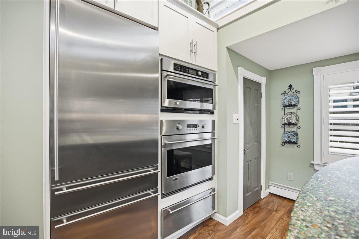 14382 Sedwick Avenue Solomons, MD 20688 - Photo 33 of 90 a kitchen with granite countertop stainless steel appliances and wooden floor