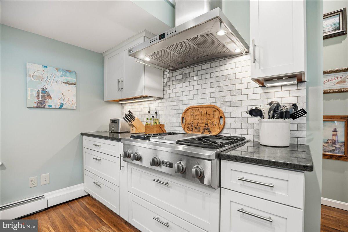 14382 Sedwick Avenue Solomons, MD 20688 - Photo 35 of 90 a kitchen with a stove and cabinets