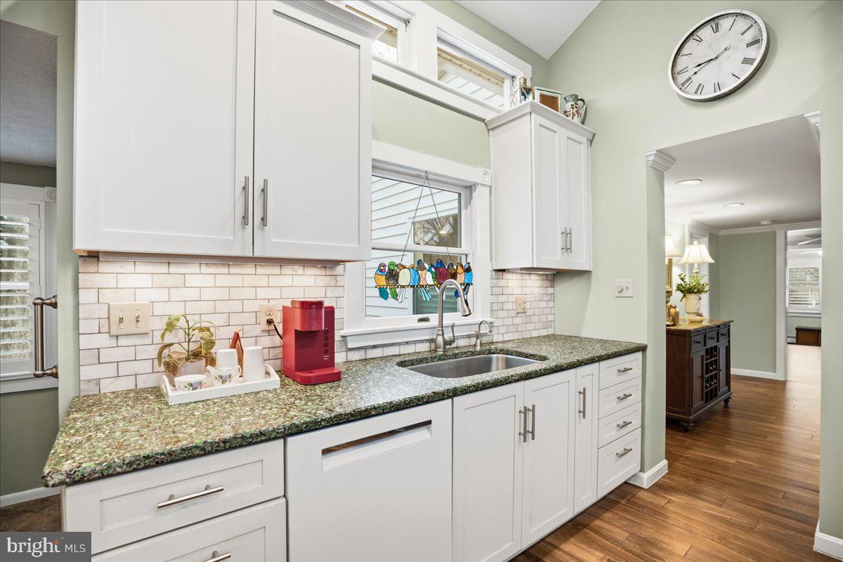 14382 Sedwick Avenue Solomons, MD 20688 - Photo 36 of 90 a kitchen with stainless steel appliances granite countertop a sink a stove and cabinets