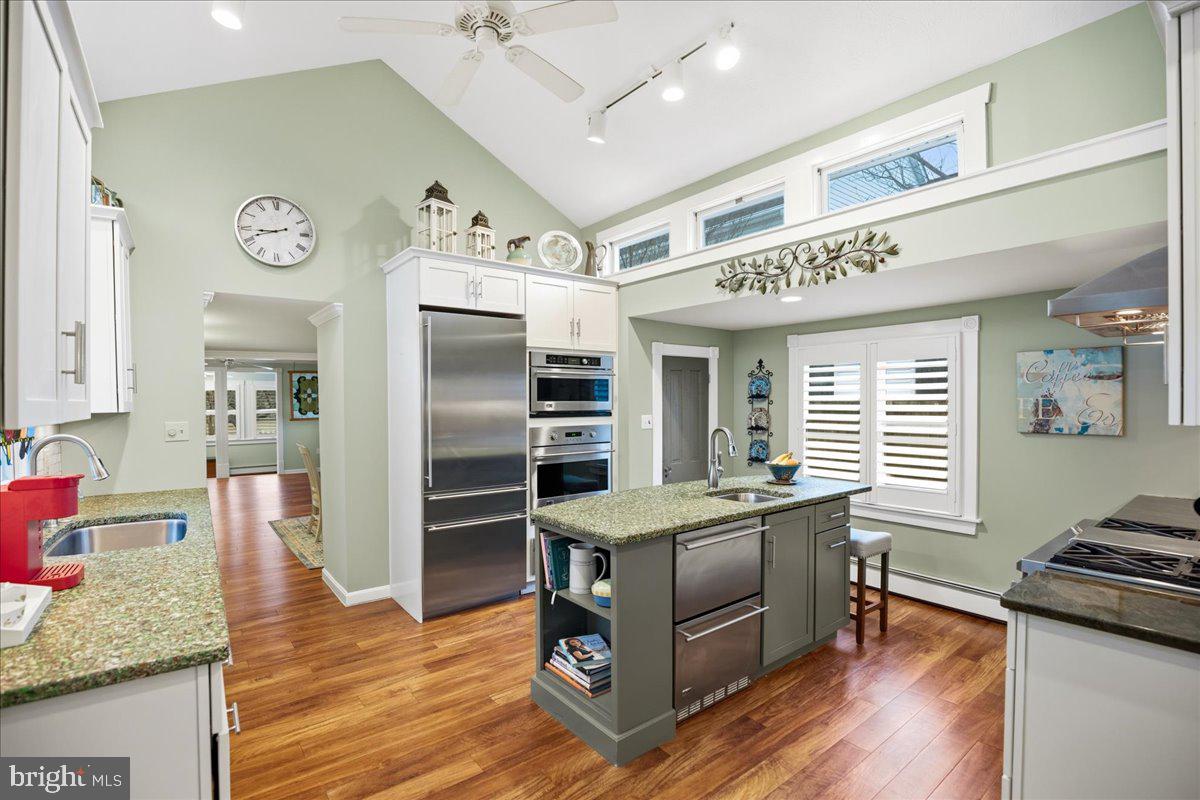 14382 Sedwick Avenue Solomons, MD 20688 - Photo 37 of 90 a kitchen with stainless steel appliances granite countertop a stove and a refrigerator