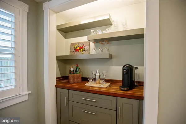 a view of staircase with lots of frames on wall and a window