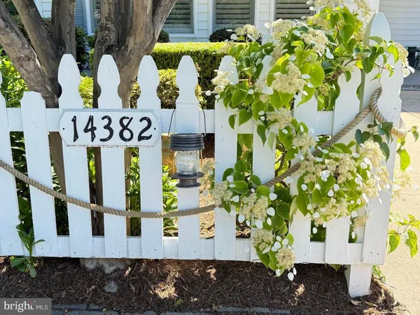 a front view of a house with a yard covered in snow