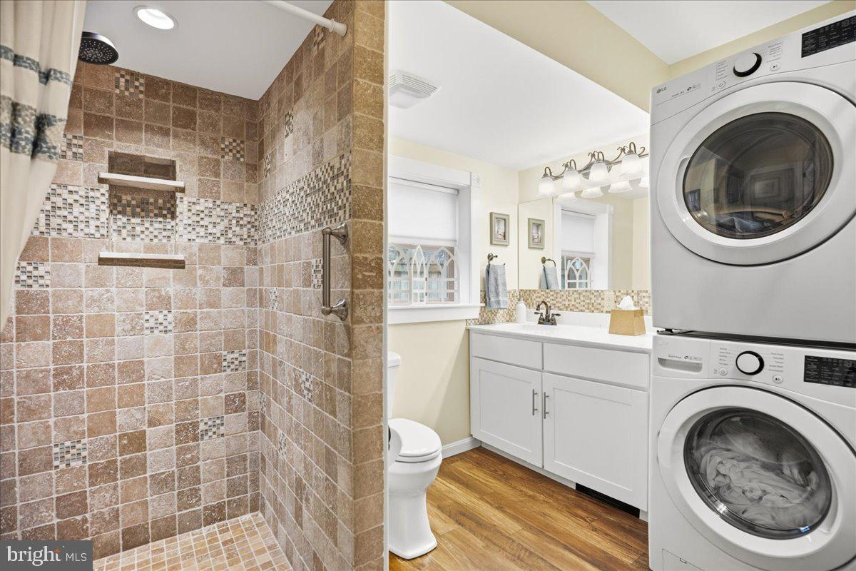 14382 Sedwick Avenue Solomons, MD 20688 - Photo 41 of 90 a bathroom with a sink a washer and dryer