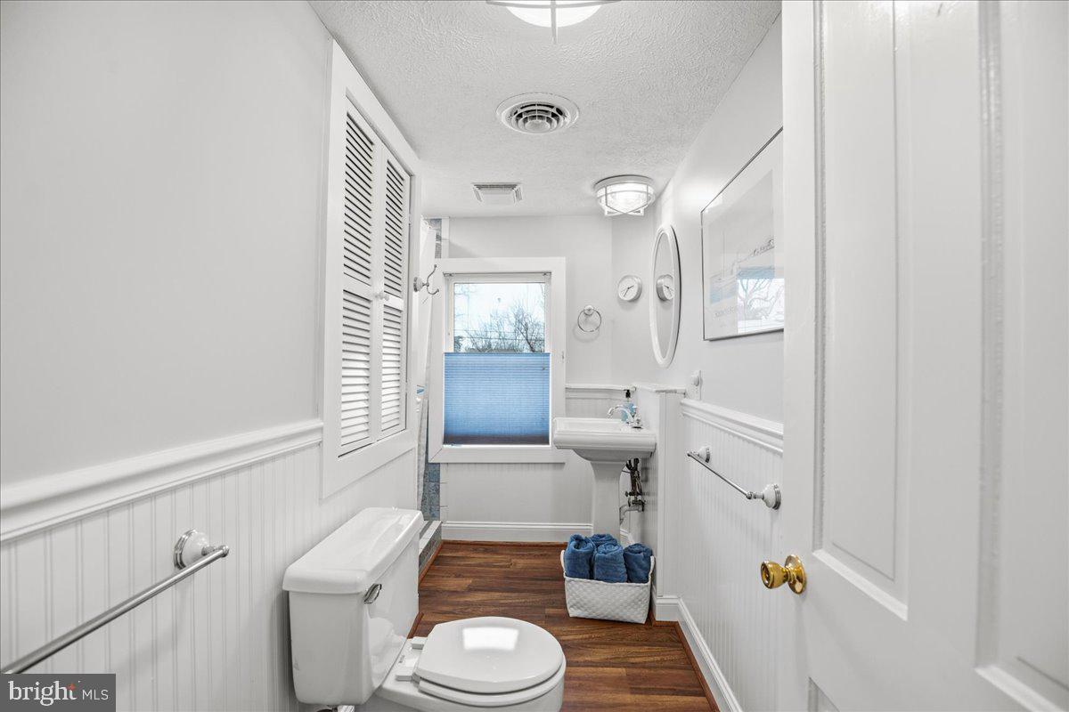 14382 Sedwick Avenue Solomons, MD 20688 - Photo 46 of 90 a bathroom with a sink mirror vanity and toilet