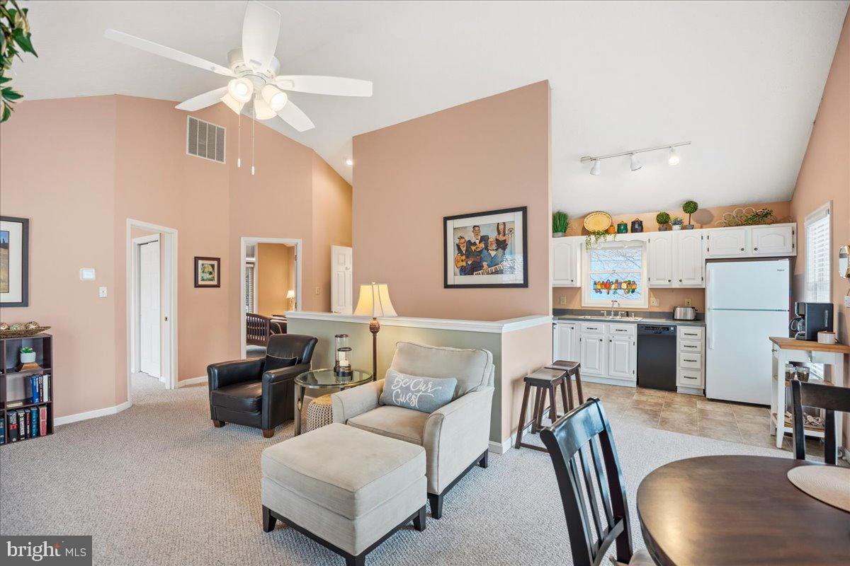 14382 Sedwick Avenue Solomons, MD 20688 - Photo 89 of 90 a living room with furniture kitchen view and a wooden floor