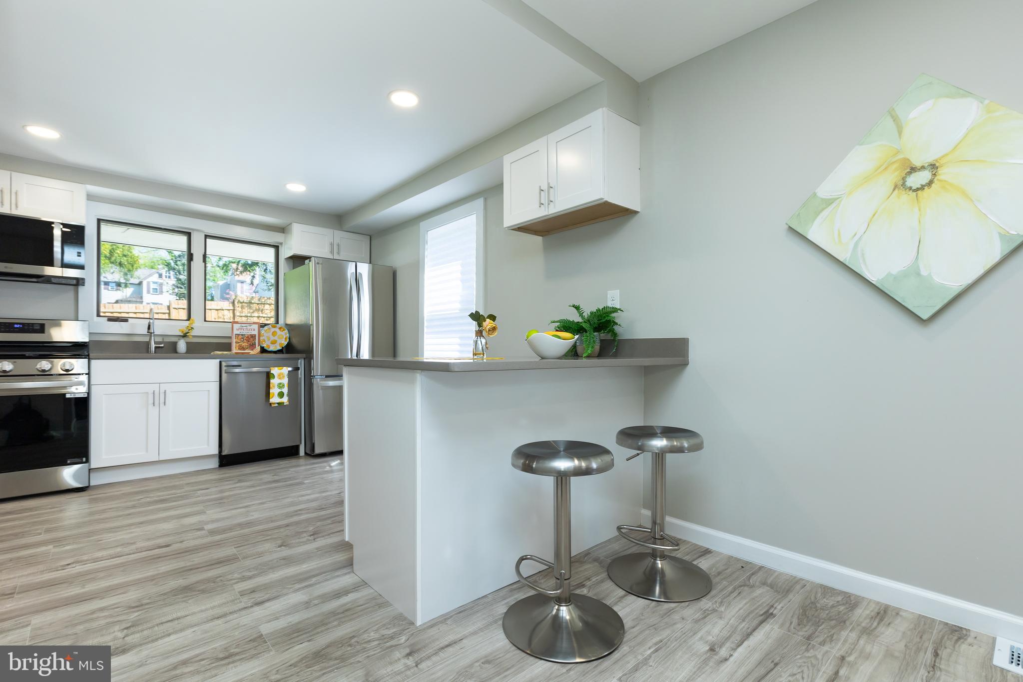 2407 Hammonds Ferry Road Halethorpe, MD 21227 - Photo 6 of 43 a kitchen with a sink cabinets and window