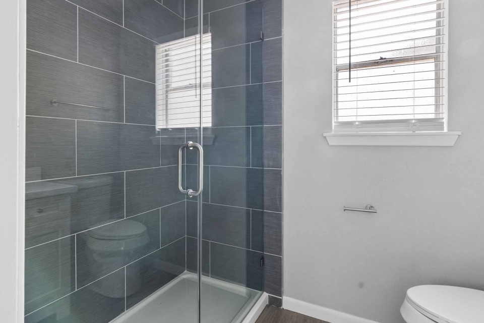 7403 Strawbridge Lane Houston, TX 77040 - Photo 16 of 22 a bathroom with a toilet and a shower