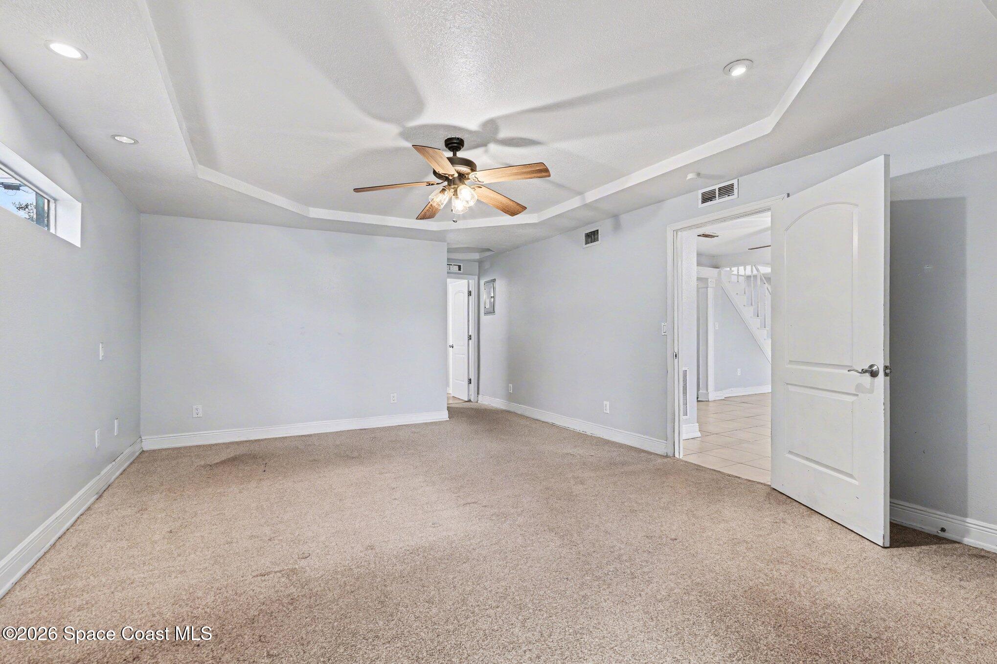 4950 Blounts Ridge Road Mims, FL 32754 - Photo 5 of 40 an empty room with ceiling fan and window