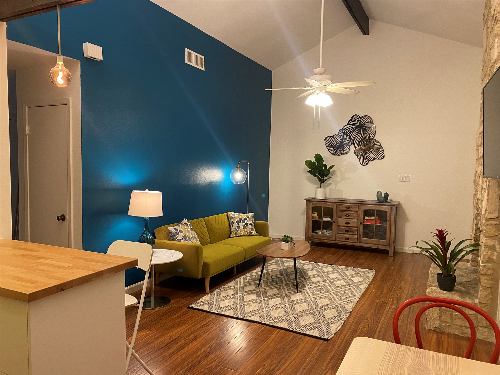 5405 Brompton Circle, Unit B Austin, TX 78745 - Photo 3 of 19 Living room with beam ceiling, a ceiling fan, wood finished floors, and high vaulted ceiling