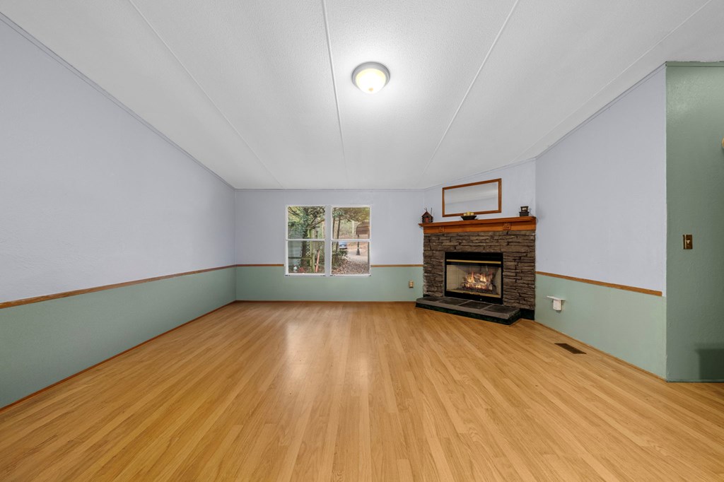 150 Curtis Switch Road Blue Ridge, GA 30513 - Photo 36 of 37 a view of empty room with a fireplace and wooden floor
