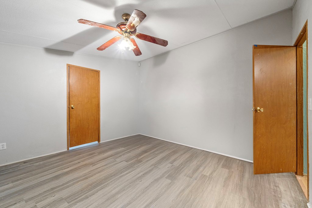 150 Curtis Switch Road Blue Ridge, GA 30513 - Photo 37 of 37 an empty room with wooden floor and fan