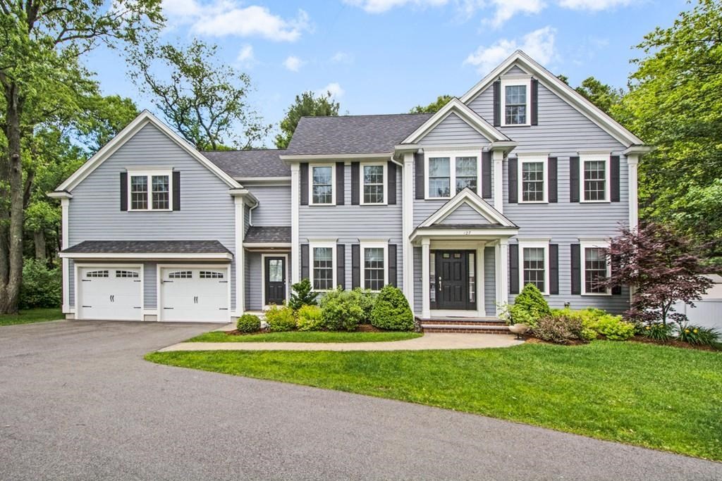 a front view of a house with a garden and plants