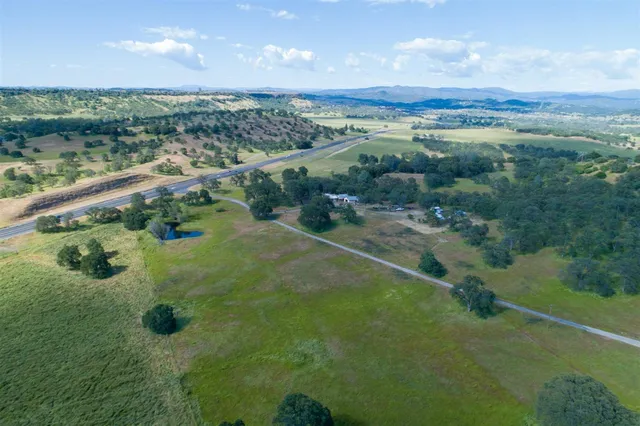an aerial view of a house with a yard and fountain