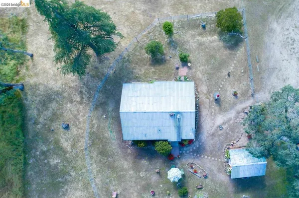 an aerial view of a house with a yard and lake view