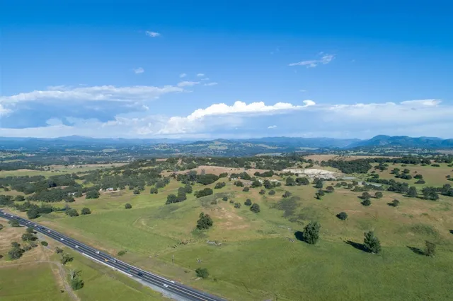 a view of a field with a house in the background