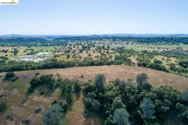an aerial view of a house with a yard and lake view