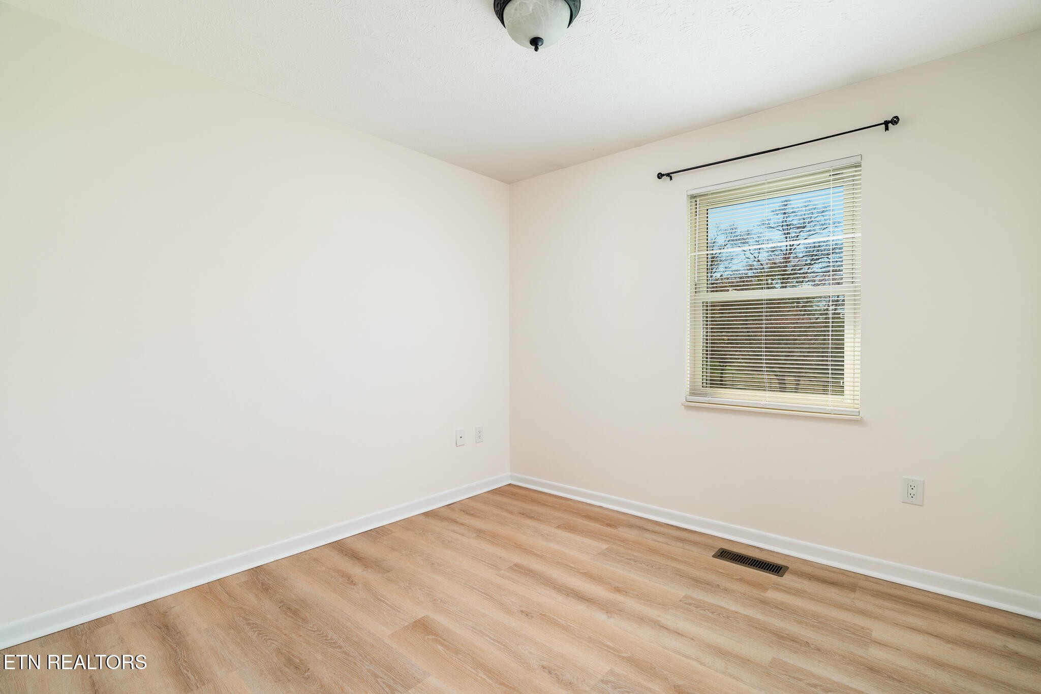 520 Harrow Road Knoxville, TN 37934 - Photo 20 of 42 a view of an empty room with wooden floor and a window