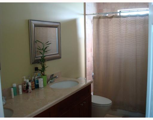 18950 Southwest 51st Manor Southwest Ranches, FL 33332 - Photo 9 of 10 a bathroom with a granite countertop sink a toilet a shower and a mirror