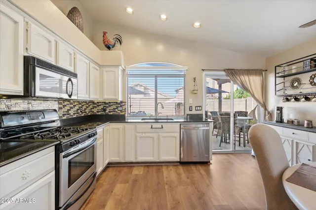 a kitchen with stove and cabinets