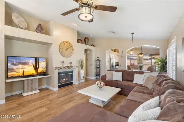 a living room with furniture a fireplace and a flat screen tv
