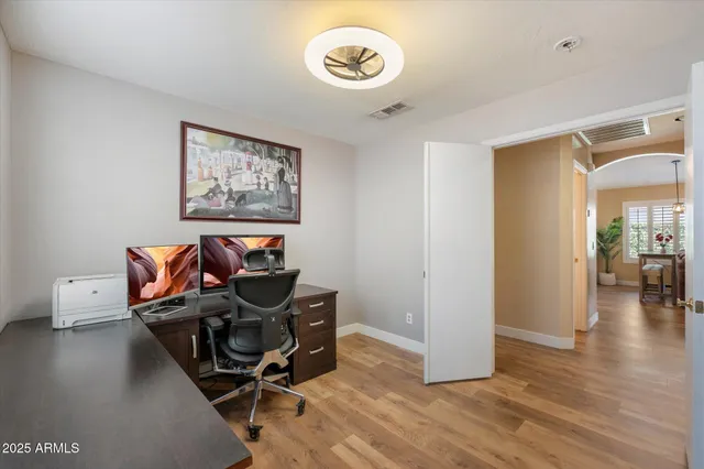 a view of a workspace with furniture and wooden floor