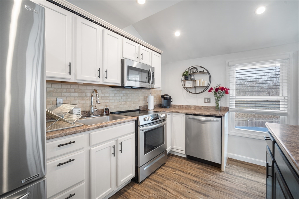 182 Wrentham Road Springfield, MA 01119 - Photo 12 of 25 a kitchen with stainless steel appliances granite countertop a sink a stove a microwave and cabinets