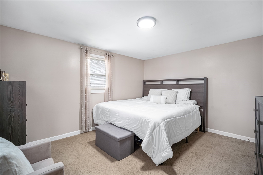 182 Wrentham Road Springfield, MA 01119 - Photo 14 of 25 a bedroom with a bed and a couch