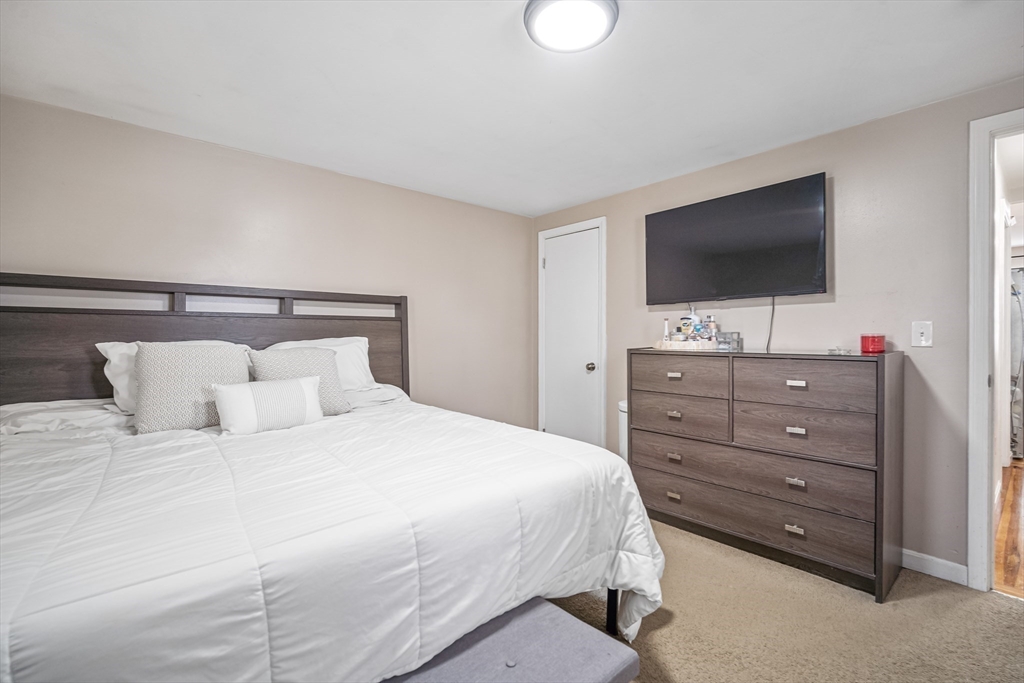 182 Wrentham Road Springfield, MA 01119 - Photo 16 of 25 a bedroom with a bed and a flat screen tv