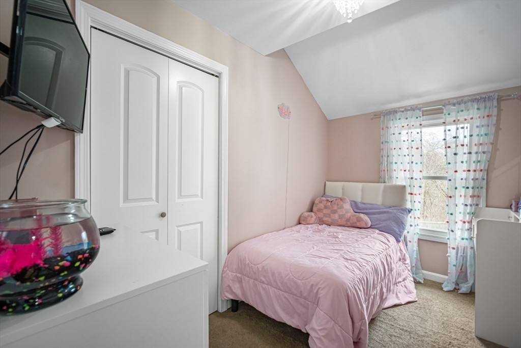 182 Wrentham Road Springfield, MA 01119 - Photo 17 of 25 a bedroom with a bed a flat screen tv and a window