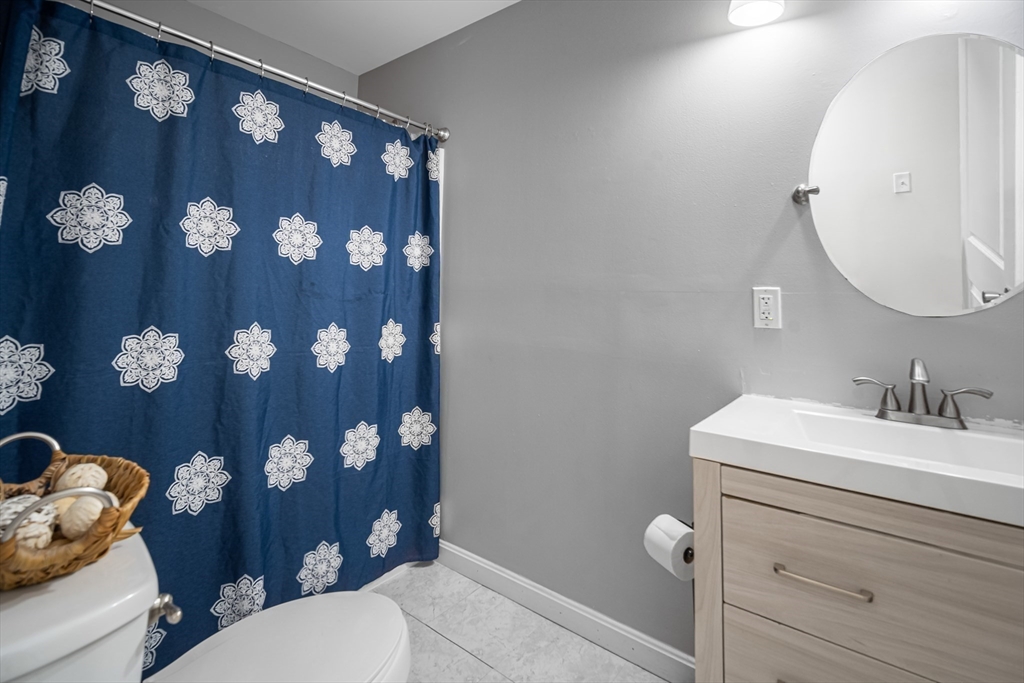 182 Wrentham Road Springfield, MA 01119 - Photo 19 of 25 a bathroom with a sink vanity mirror and toilet