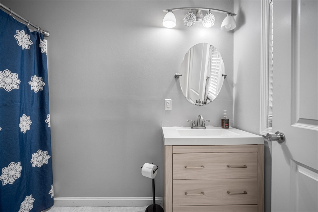 182 Wrentham Road Springfield, MA 01119 - Photo 20 of 25 a bathroom with a sink vanity and a mirror