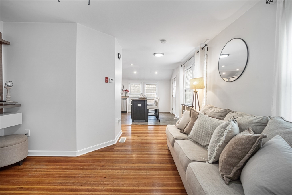 182 Wrentham Road Springfield, MA 01119 - Photo 8 of 25 a living room with furniture a mirror and a chandelier