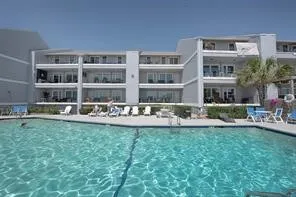 a front view of a building with outdoor seating and yard