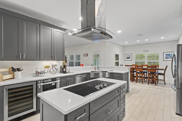 a kitchen with a stove a table and chairs