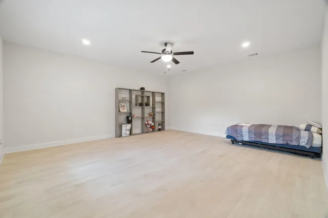 a bedroom with a bed and a large window