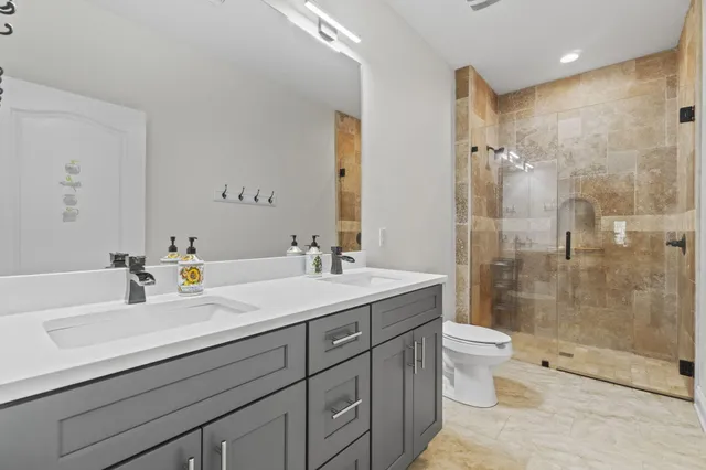 a bedroom with a bed and a ceiling fan