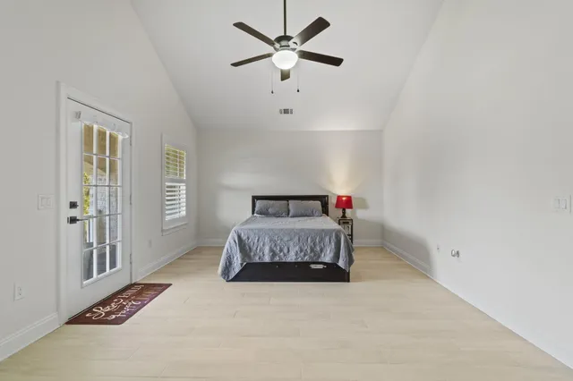a bedroom with a large bed and a chandelier