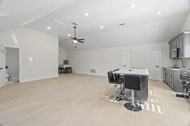 a bathroom with a sink a toilet and shower curtain